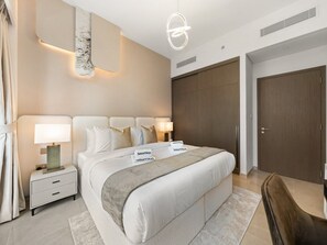 A modern hotel room with a large bed, bedside tables, a nightstand, a lamp, a headboard, and a wardrobe. - New 1BR | Burj Khalifa Infinity Pool | Dubai Mall (Dubai)