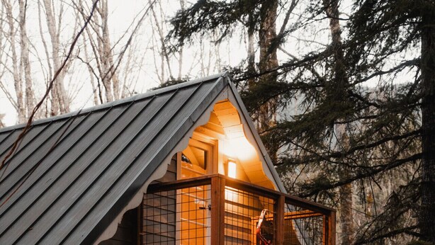 A two-story wooden cabin with a balcony, a front door, and a mailbox. - Mt Rainier Cabin! Sauna, Game Rm, Hot Tub, Firepit (Ashford)