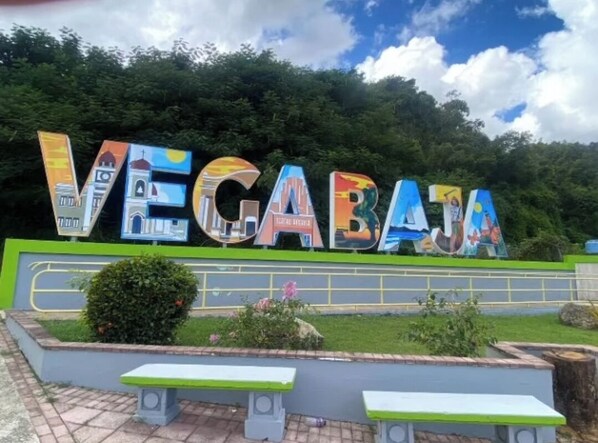 A sign with the word "VEGABAJ" and colorful illustrations of buildings and landmarks. - 3-bedroom house 10 minutes from the beach in welcoming Vega Baja, Puerto Rico.  (Vega Baja)