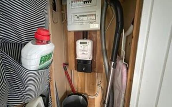 A compact bathroom with a toilet, a hand dryer, and a white bottle on the floor. - 8 Person Holiday Home in Asnaes (Asnaes)