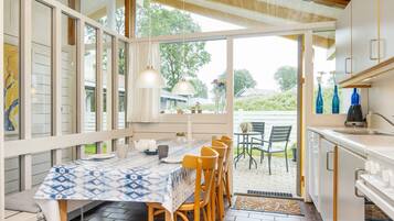 Una cocina con comedor, ventanas amplias y vistas al exterior.