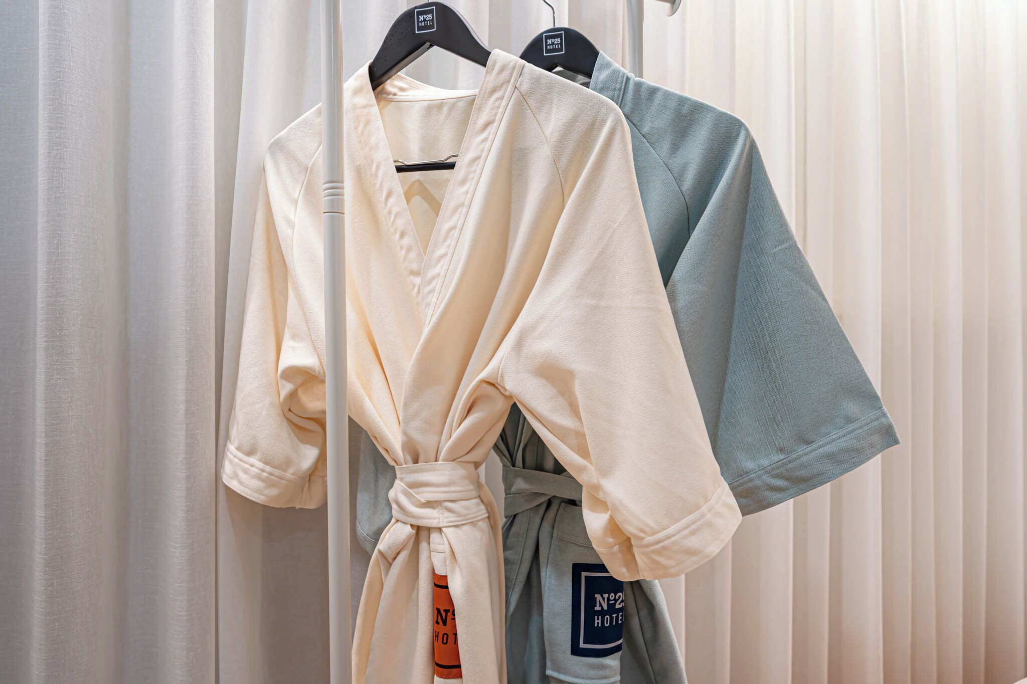 A rack of robes in a hotel setting.