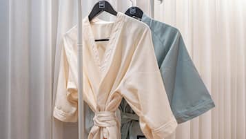 A rack of robes in a hotel setting.