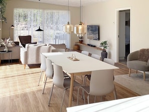 Un comedor moderno con una mesa y sillas blancas, luces colgantes y vistas a través de una ventana con persianas verticales.