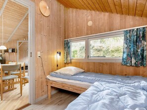 A wooden cabin room with a bed, a desk, and a chair. - 4 Star Holiday Home in Nysted (Nysted)