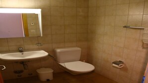 A small bathroom with a sink, toilet, and a trash bin. - Cozy Apartment With Rhone Valley View (Nendaz)