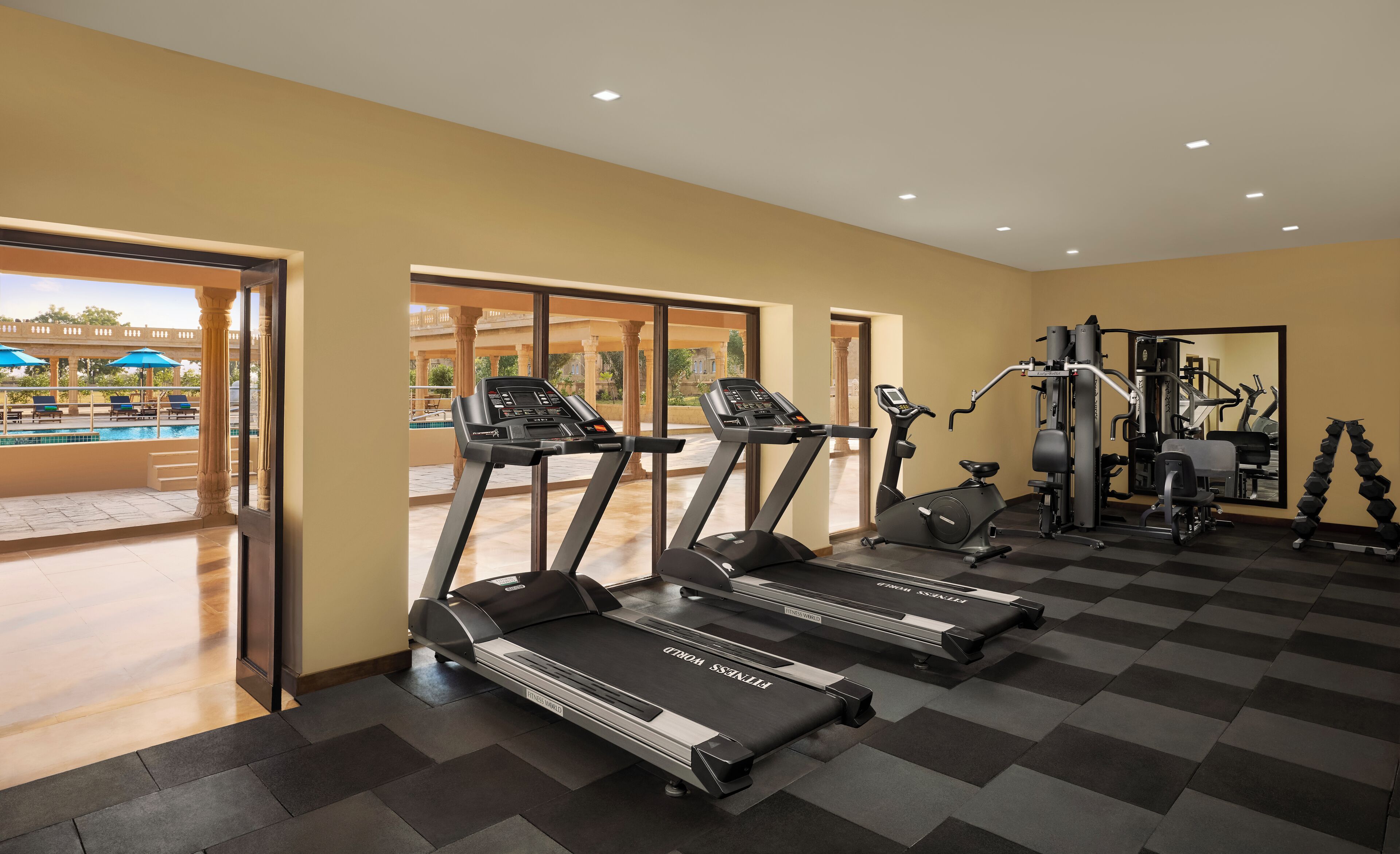 A gym with treadmills, a stationary bike, and weight machines.