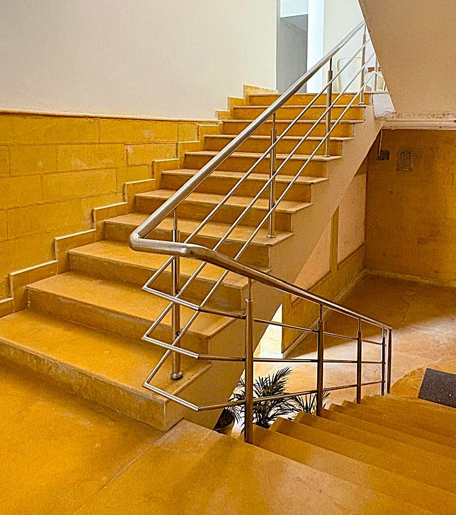 A staircase with metal handrails and wooden steps.