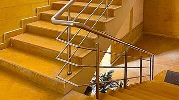 A staircase with metal handrails and wooden steps.