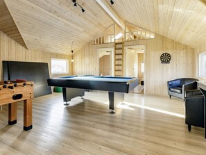 A wooden interior with a pool table, foosball table, and dartboard. - 4 Star Holiday Home in Lokken (Lokken)