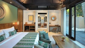 A modern hotel room with a large bed, a sofa, a dining table, and a view of the outdoors. - The Sebali Penida Beach Resort (Penida Island)