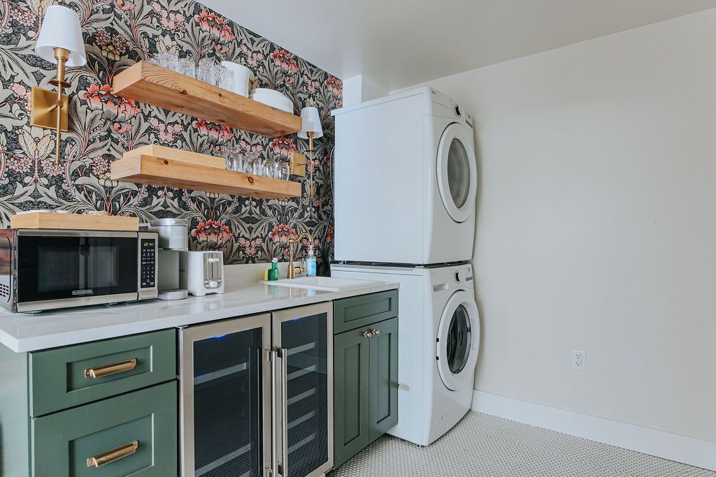 A compact kitchen with a microwave, toaster, and washing machine.