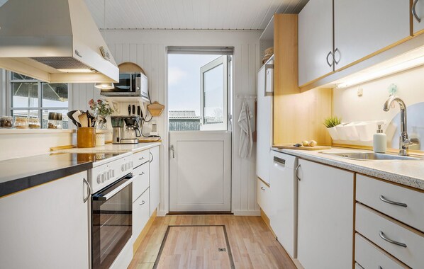 Fridge, stovetop, dishwasher, coffee/tea maker