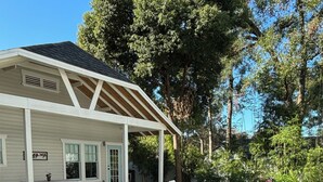A house with a covered porch, a lawn, and a patio area.