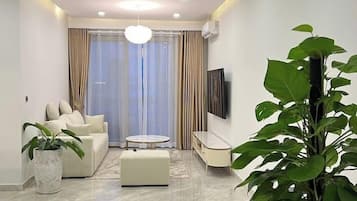 Superior Apartment, 3 Bedrooms, Kitchen, City View | Living area | 35-inch TV with cable channels