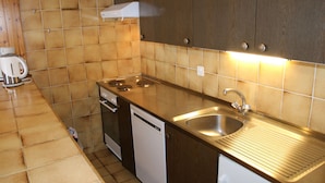 A compact kitchen with a stove, sink, and dishwasher. - Stunning Apartment With Mountain Views (Veysonnaz)