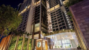 A modern hotel with multiple floors, large windows, and a well-lit entrance. - D'Edge Thao Dien (Ho Chi Minh City)
