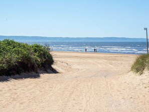 A sandy beach path leading to the ocean with a clear sky. - 6 Person Holiday Home in Skummeslovsstrand (Skummesloevsstrand)