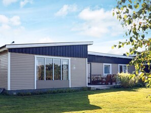 A modern two-story house with large windows and a covered patio area. - 6 Person Holiday Home in Skummeslovsstrand (Skummesloevsstrand)