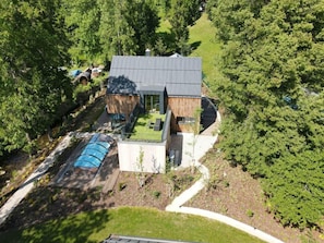A modern house with a large deck, a swimming pool, and a well-maintained garden. - Spacious Villa With Good Ambience (Cerny Dul)