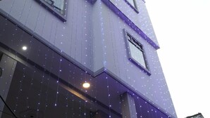 A multi-story building with a modern architectural design, featuring large windows and a flat roof. - Hotel Imperial Kashi (Varanasi)