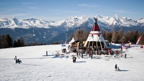 A ski resort with a prominent teepee structure, ski lifts, and a snowy mountain backdrop. - Apartment With Swimming Pool Access (Veysonnaz)