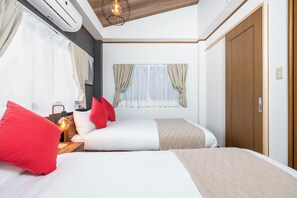 A bedroom with two beds, a wooden ceiling, an air conditioning unit, and a window with curtains.
