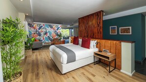 A modern hotel room with a large bed, wooden headboard, a small desk, and a view of the outdoors. - 258 Hotel (Harare)