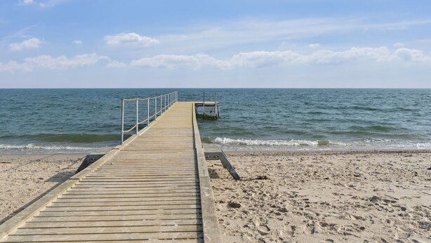 A wooden pier extending into calm waters with a clear sky. - "Bjarni" - 175m from the sea by Interhome (Malling)