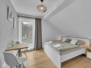 A modern bedroom with a single bed, a wooden desk, and a chair. - Holiday Villa for Larger Groups (Cerny Dul)