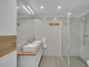 A modern bathroom with two sinks, a shower, and a wooden countertop. - Holiday Villa for Larger Groups (Cerny Dul)