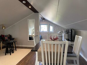 A dining area with a high ceiling, a window with a view, and a television. - 4 Person Holiday Home in Frandefors (Frändefors)