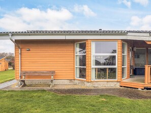 A modern building with a wooden exterior, large windows, and a small porch area. - 4 Star Holiday Home in Vestervig-by Traum (Vestervig)