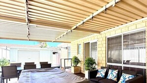 An outdoor patio with a pool table, a sofa, and a brick floor. - 22 Home Sweet Home Coastal Currambine (Currambine)