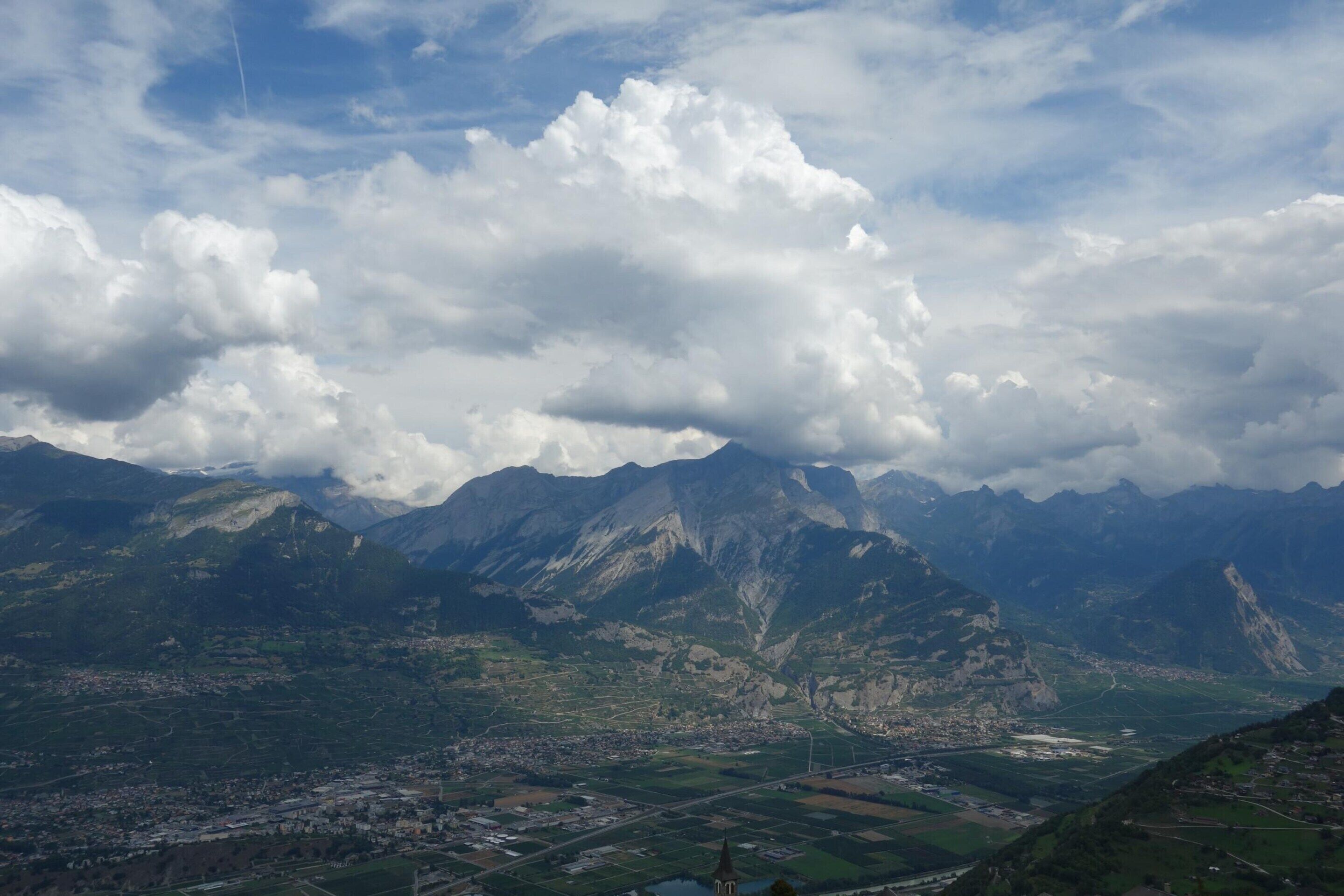 A mountainous landscape with a town in the valley.