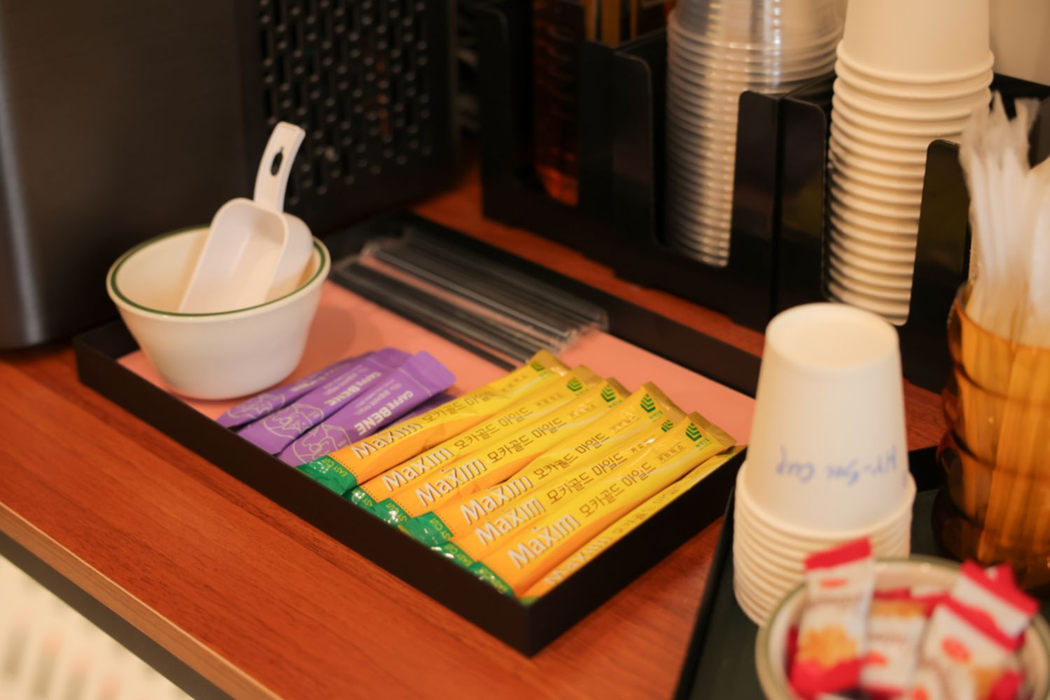 A tray with food items and a bowl on a table.