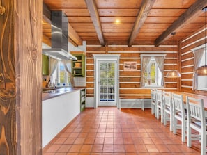 A rustic wooden interior with a kitchen, dining area, and a view through a door. - Horni Marsov Khk320 Comfortable Holiday Residence (Horni Marsov)