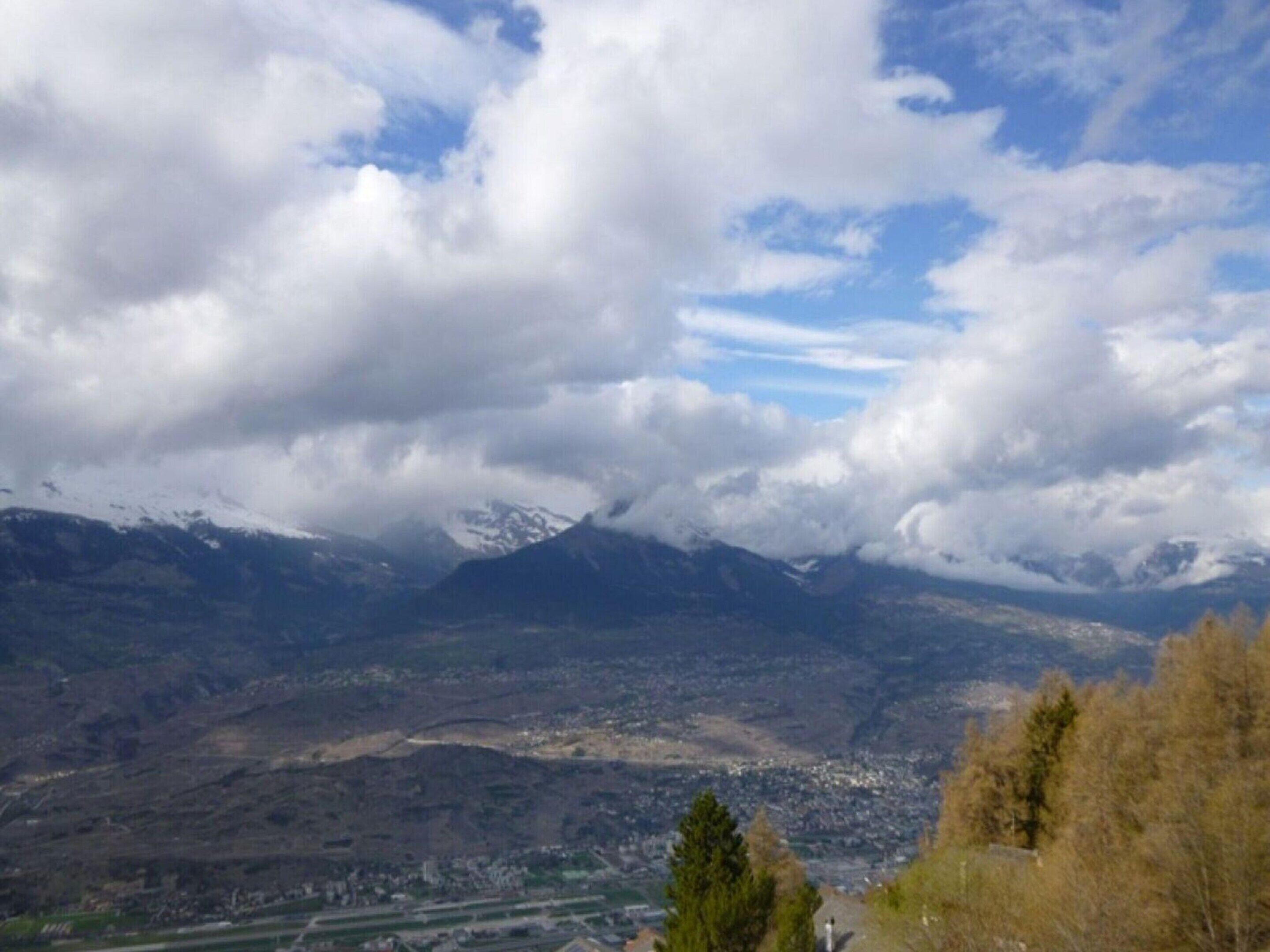 A mountainous landscape with a town in the valley below.