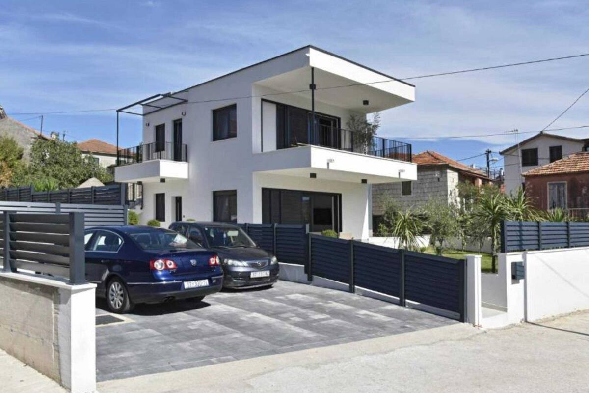 A modern two-story house with a garage parking two cars.