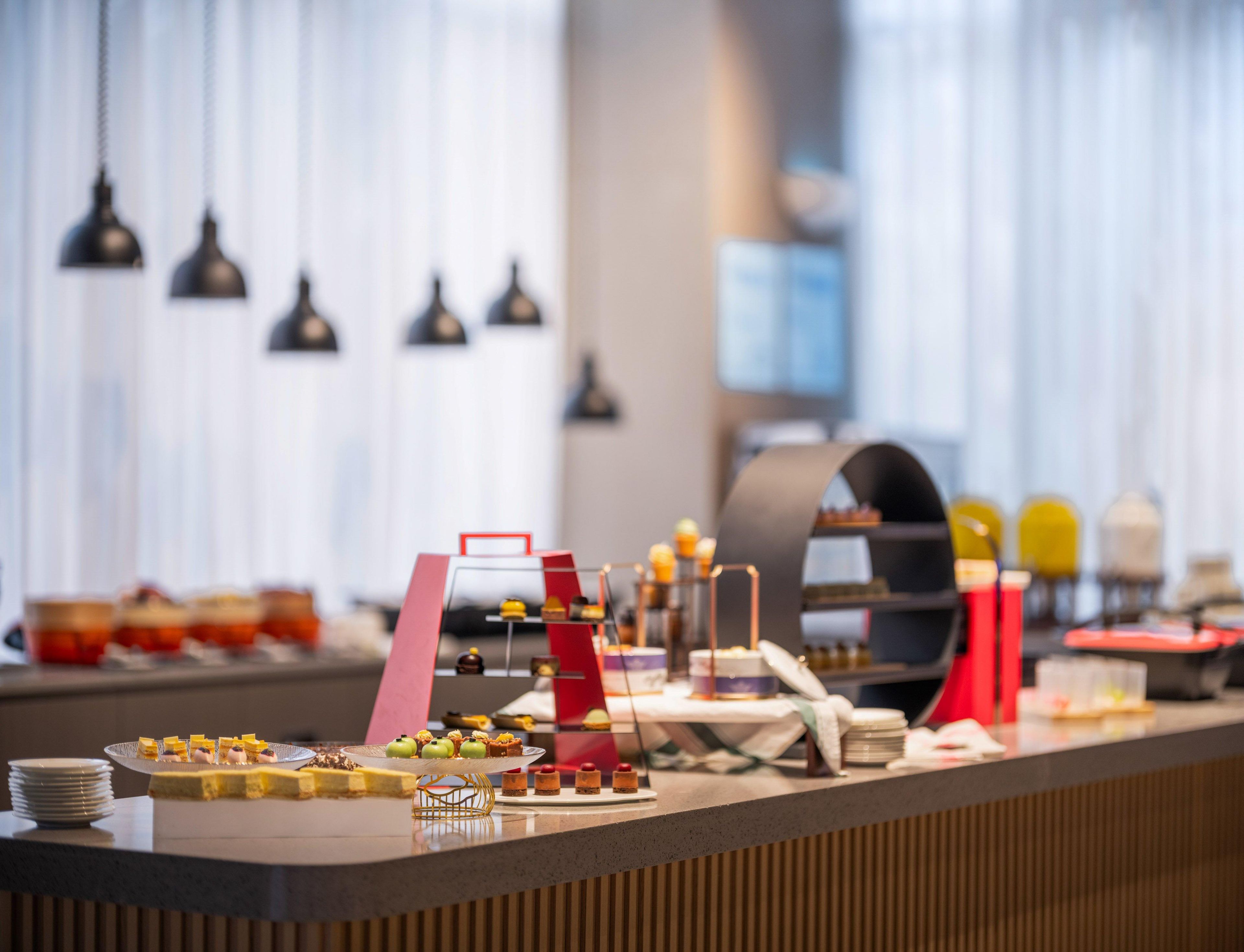 A buffet setup with various desserts and a coffee station.