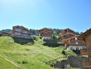 A cluster of wooden chalets on a hillside with a clear sky. - Les Mayens MB 001 - Luxury Apartment 8 Pers (Veysonnaz)