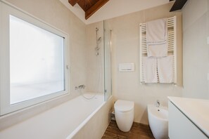 Bidet, towels, soap, toilet paper