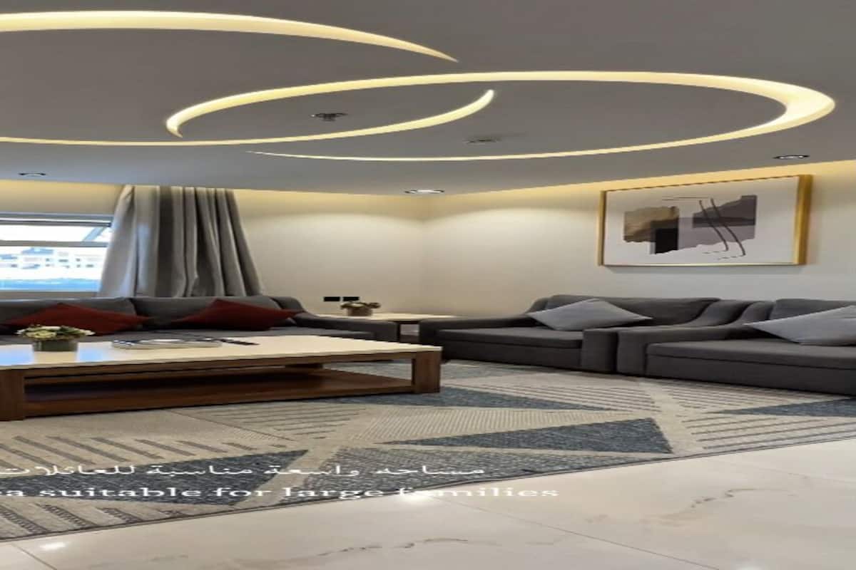 A modern living room with a sofa, coffee table, and a television.