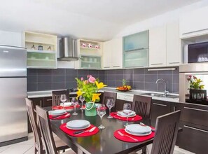 Enjoy cooking and dining in this well-equipped kitchen with a central island, oven, and sink.