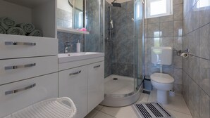 A modern bathroom with a glass-enclosed shower, a toilet, and a sink with a mirror. - Peaceful and Cozy Holiday Home Near Imotski (Sestanovac)