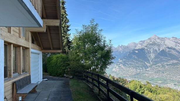 A wooden building with a balcony overlooking a mountain view. - Chalet With Mesmerizing Mountain View (Veysonnaz)