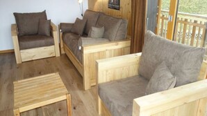 A wooden interior with two sofas and a small table. - Ski Lift Apartment With Views (Veysonnaz)