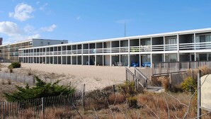A modern building with multiple balconies and large windows. - Charming 2 bedroom direct oceanfront townhouse in family friendly midtown. (Ocean City)