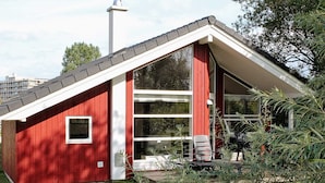 A red building with a sloped roof and large windows. - 5 Star Holiday Home in Grossenbrode (Grossenbrode)