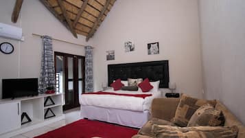 Luxury Suite, Garden View | In-room safe, desk, laptop workspace, iron/ironing board